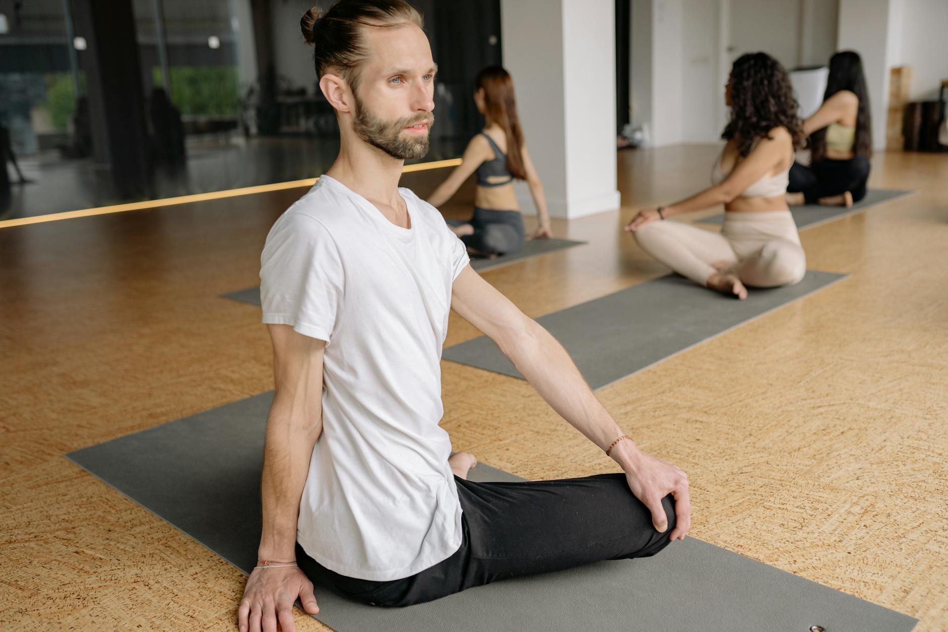 Person meditating peacefully in a yoga class.